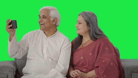 Old-Indian-couple-making-a-vlog-for-social-media-Green-screen