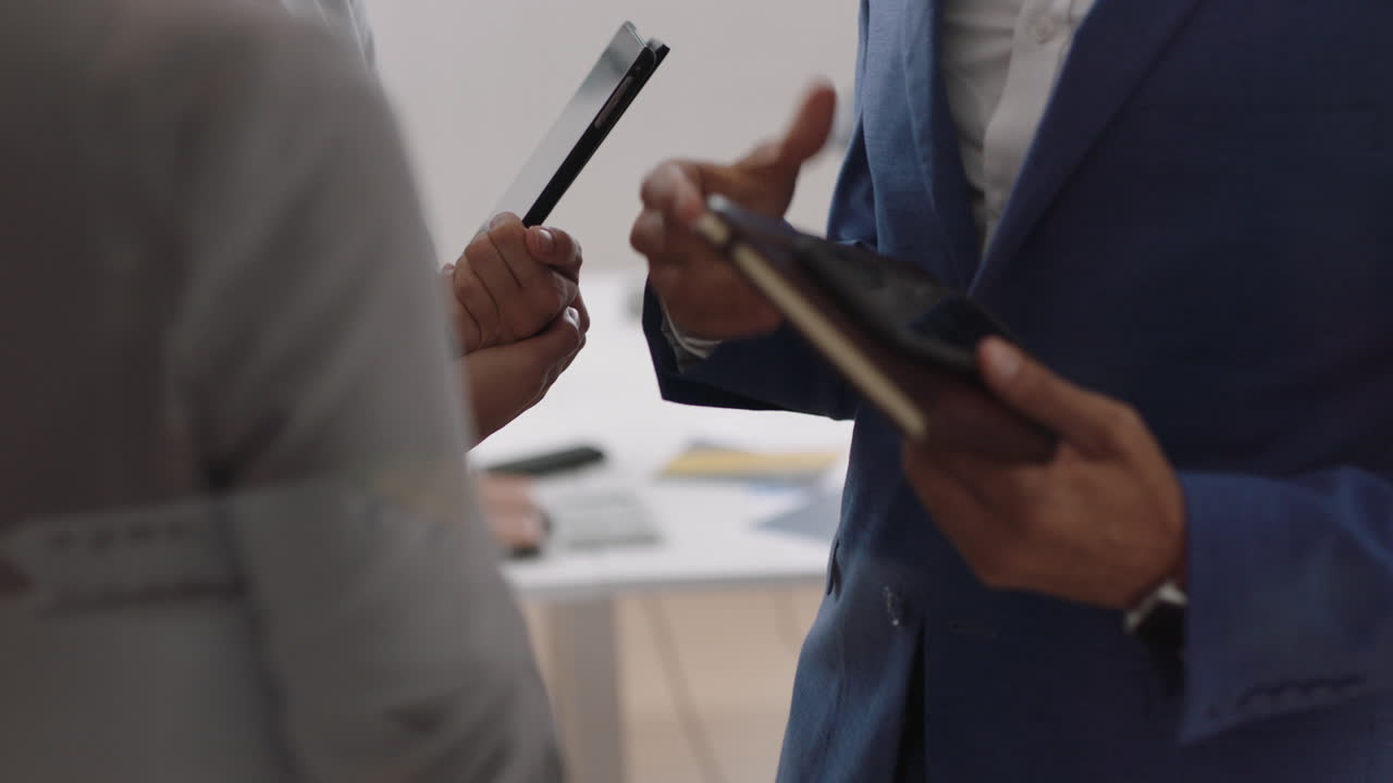 businessman meeting clients shaking hands professional business people using tablet computers planning partnership deal in startup office workspace