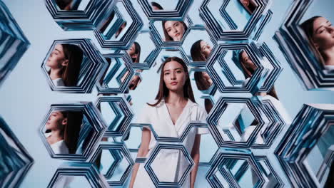 woman reflected in hexagonal mirrors