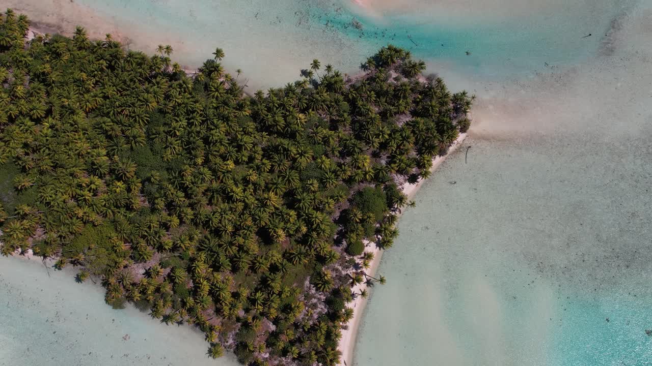 Beautiful Aerial drone shot of the lagoon, reef and ocean of  the atoll of Fakarava, French Polynesia, south pacific. Camera slowly tilts up