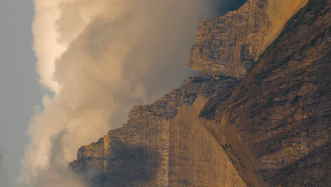 vertical 4k timelapse, clouds formation above steep rocky peak