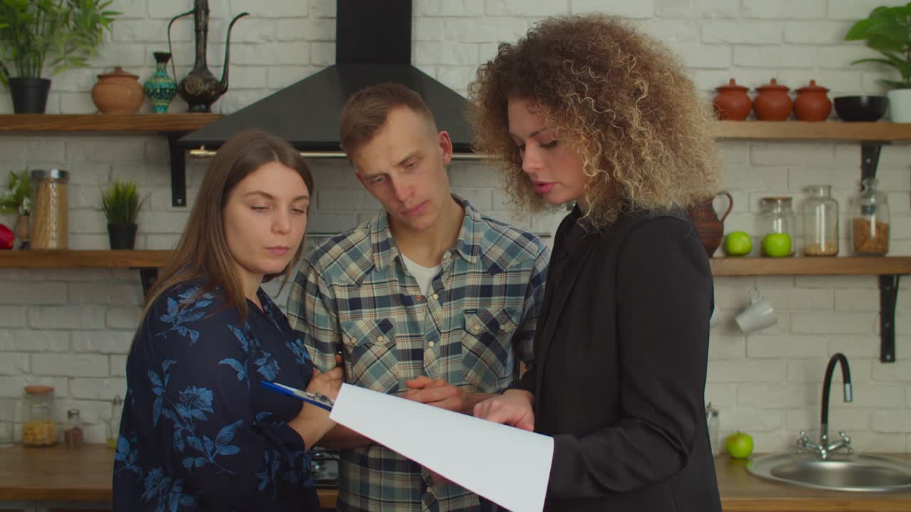 Pretty woman Real Estate Agent showing real estate agreement to couple of potential buyers