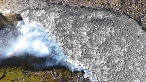 top-down shot overhead gullfoss waterfall flowing creating a rainbow in the canyon