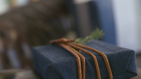 A-Christmas-Present-Package-on-a-Leather-Couch-Sofa-in-Slowmotion