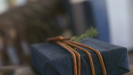 a christmas present package on a leather couch sofa in slowmotion