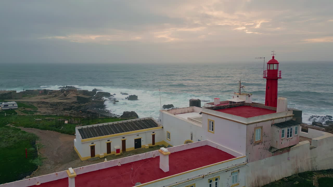 Aerial view cloudy evening horizon over  endless ocean. Red lighthouse