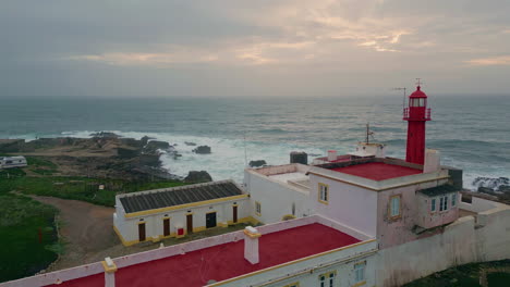 aerial view cloudy evening horizon over  endless ocean. red lighthouse