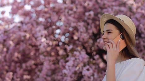 woman talking on phone in a cherry blossom tree