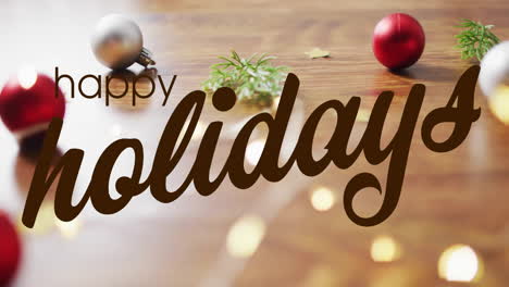 animation of happy holidays text over christmas decorations on wooden background