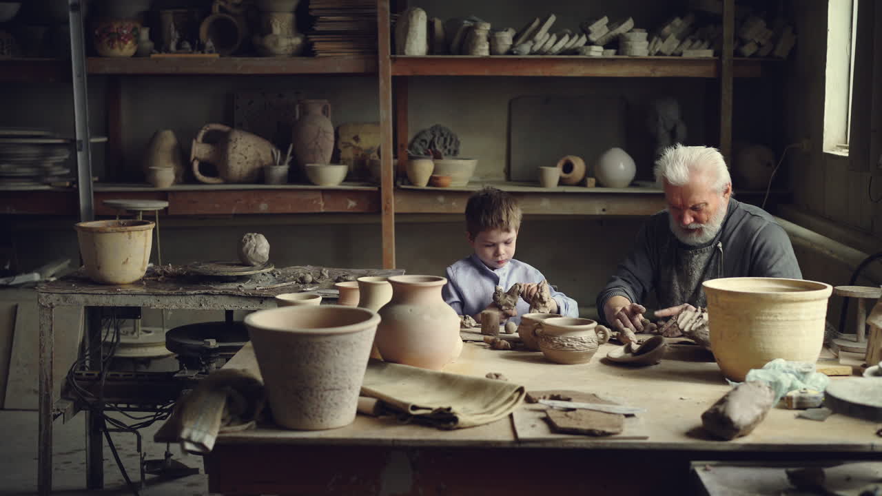 Grandfather and Grandson Working on Pottery in a Workshop