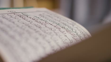 close up of open copy of the quran on stand at home 7