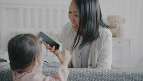 Mother and Daughter Playing with a Phone