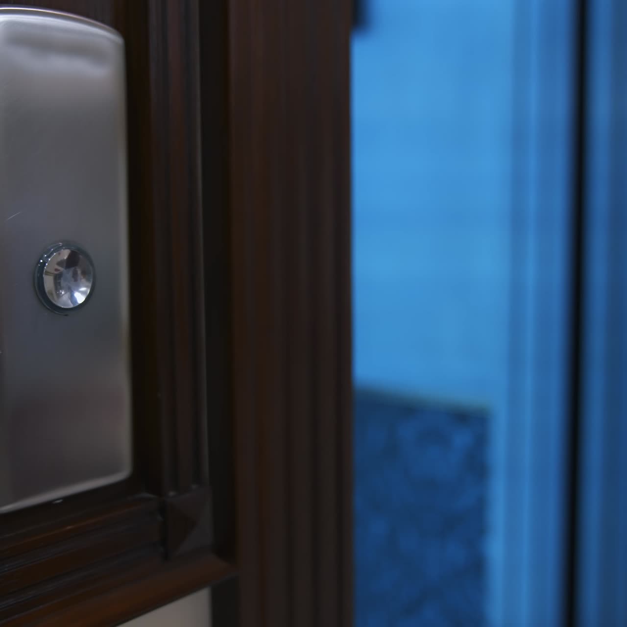 Woman`s hand presses button in an elevator. Unrecognizible woman in white shirt enters elevator. Selective focus