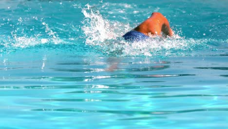 fit swimmer doing the front stroke in the swimming pool