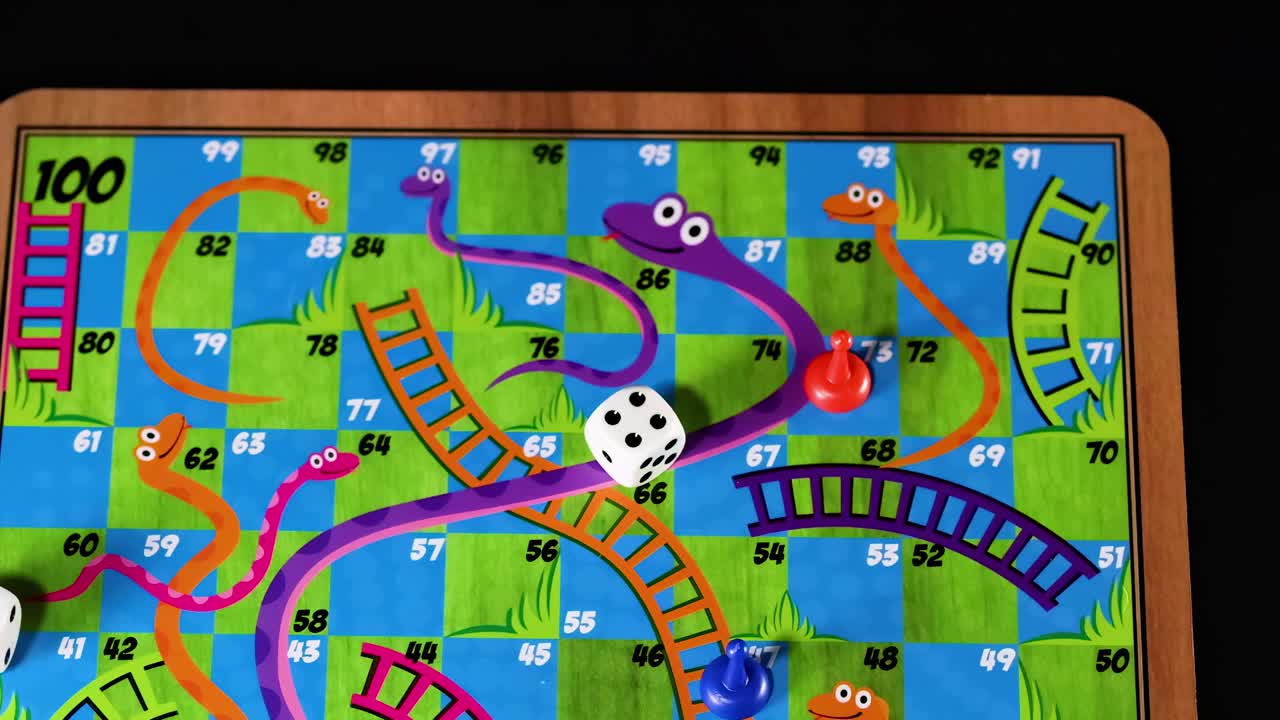 A hand moves pieces and rolls dice on a vibrant board with snakes and ladders.