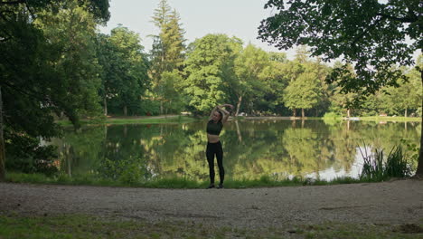 woman yoga, stretching by the lake, warm up