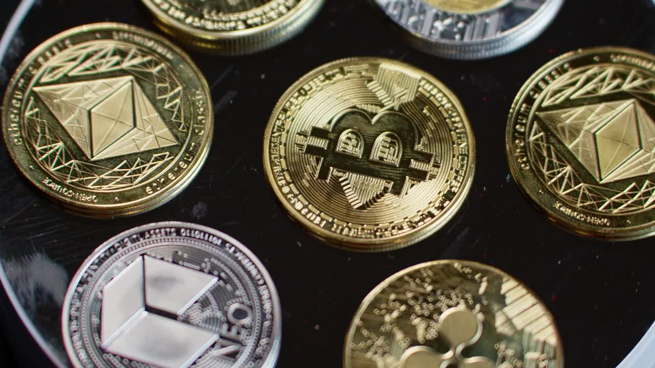Cryptocurrency tokens rotating counterclockwise, symbolizing bitcoin in the middle, then Neo, Ripple, Ethereum, Litecoin, Tether.