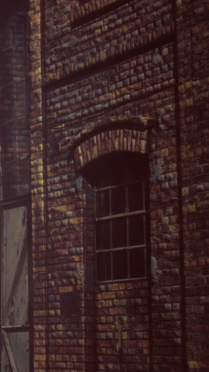 Brick wall with window in an old building during the day
