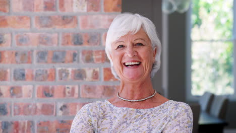 smiling senior woman walks into focus looking to camera