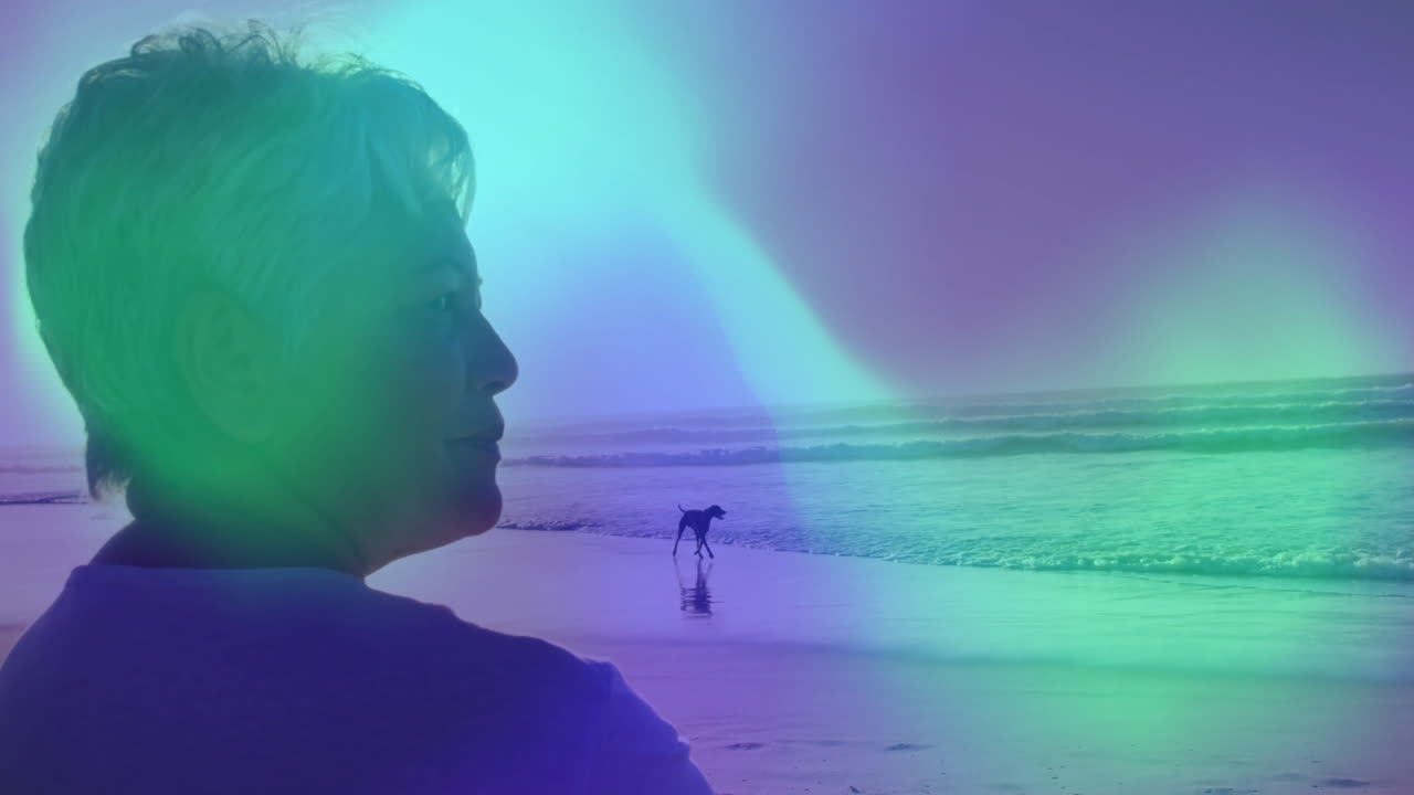 senior woman gazing out toward ocean on beach in health campaign, featuring animated heart icon