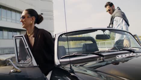 couple inspecting a vintage convertible car