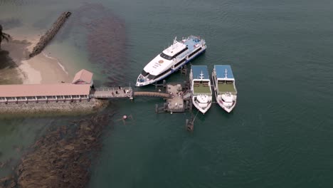 aerial view of tourists getting out from ferry boat in the saint john's island pier, singapore