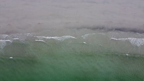 norwegian beach with green water and waves