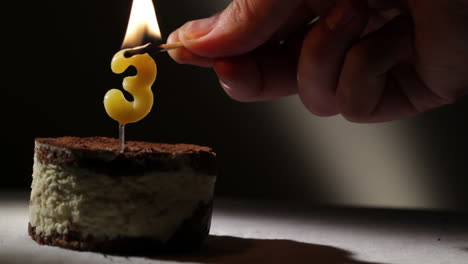 candle three in tiramisu cake