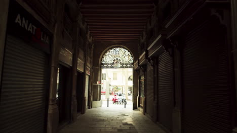 small and dark street in the gothic quarter of barcelona