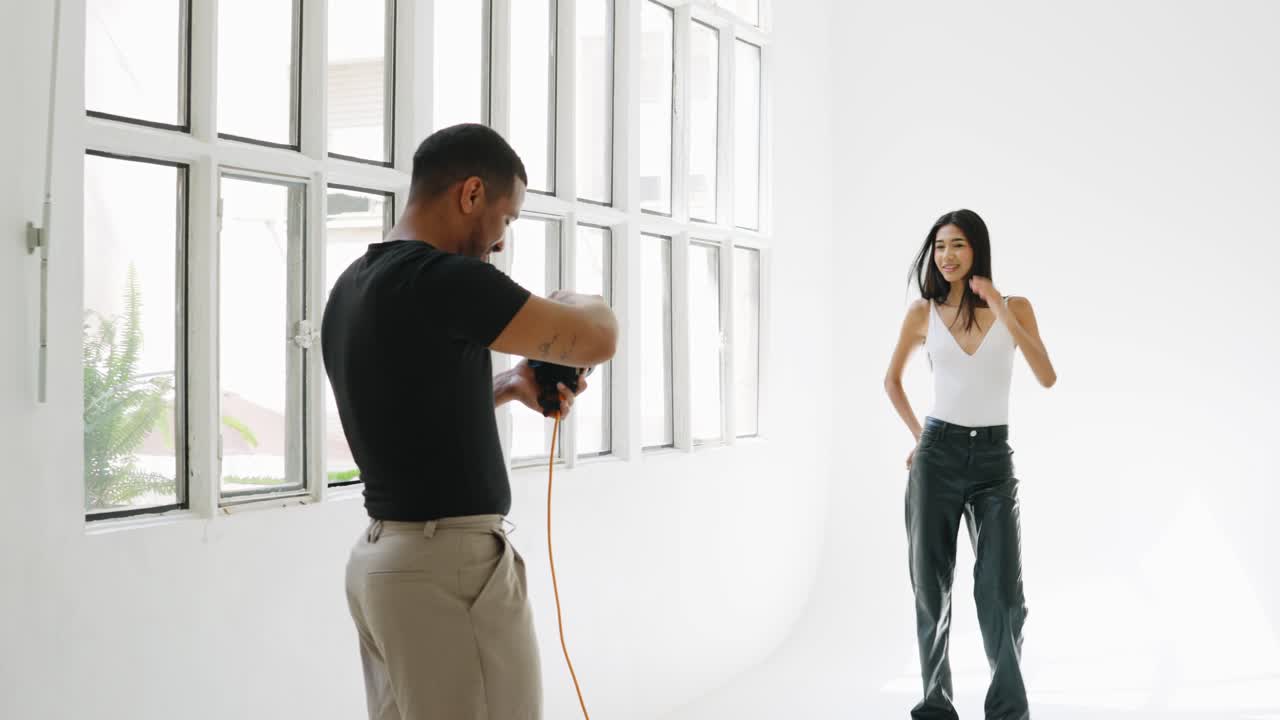 Fashion photography in a studio with a photographer and a model