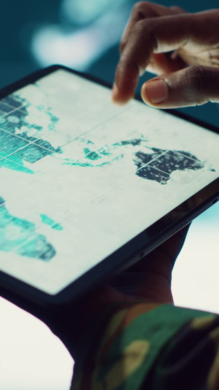 Close-Up of Hands Using Tablet with Digital World Map