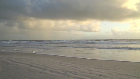 waves splashing on the beach at high tide during sunrise at the atlantic ocean central florida