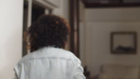 African-American-girl-blowing-kiss-while-looking-at-mirror