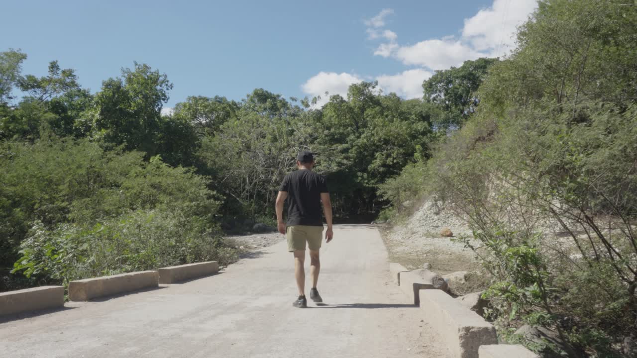 Man walking along a dirt road, in the department of El Paraíso in Honduras
