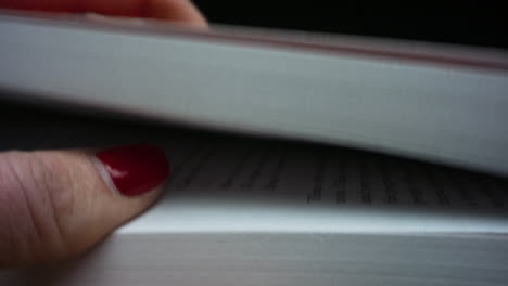 Closeup-woman-holding-book-in-hands.-Female-hands-putting-book-on-black-table.