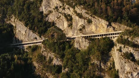 aerial view of a mountain road cut into a cliffside