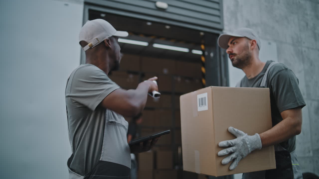 Delivery and Logistics Team Handling Packages at a Warehouse