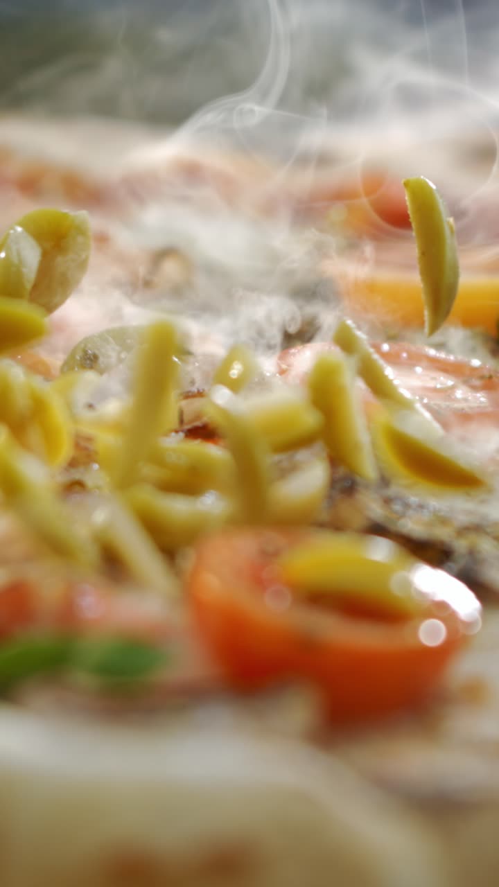 Close-up of a steaming pizza with fresh toppings
