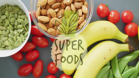 super foods text animation over healthy fruits, nuts, and vegetables