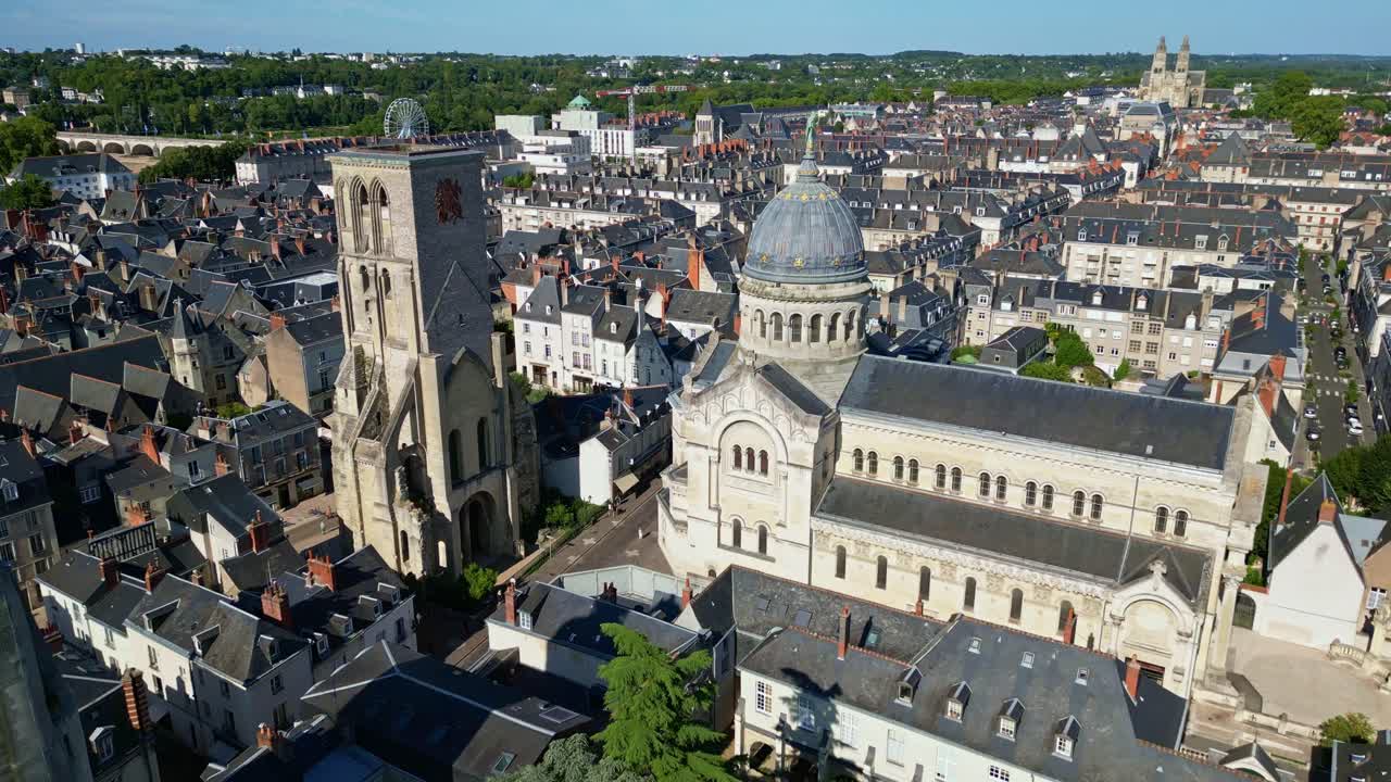 Basilica of Saint-Martin and clock tower in Tours, town cityscape, France. Aerial drone backward