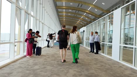 family strolls through airport terminal in krabi