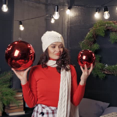 woman with big christmas balls and presents. lady in good mood before holidays. new year and christmas concept