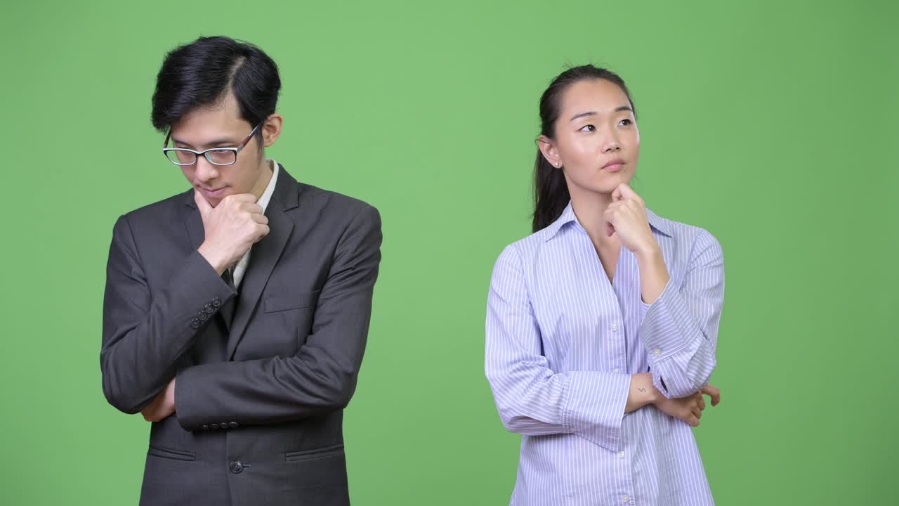 Young Asian business couple thinking together