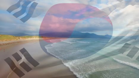 Digital-composition-of-waving-south-korea-flag-against-aerial-view-of-the-beach-and-the-sea