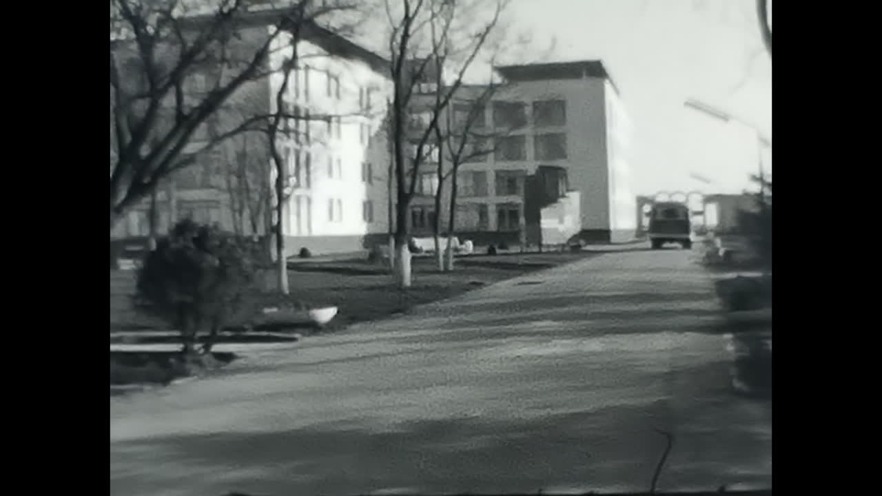 Black and White Street Video With Background Building in Soviet Union. CIRCA USSR 1970: A vintage black and white video capturing a street scene with a building in the background, showcasing the essence of the Soviet Union.