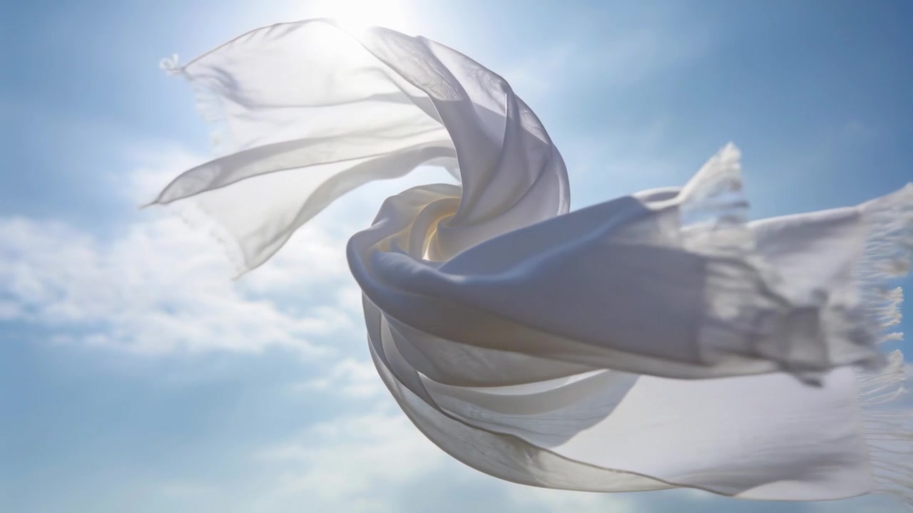 Floating white sheer scarf twisting in blue sky, breeze lifting fabric, sun backlighting fringes