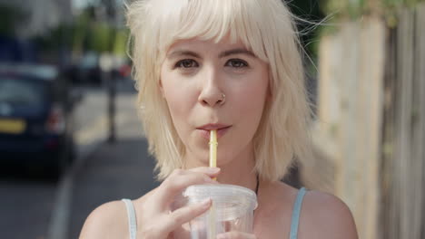 slow motion portrait of happy beautiful caucasian woman drinking juice