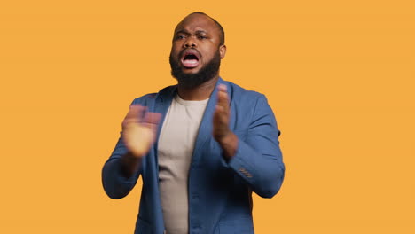 joyful man happily clapping hands, ecstatic, studio background