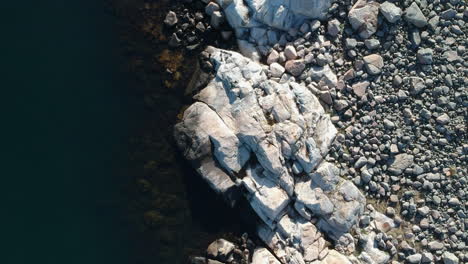 aerial drone dolly overhead view shot of a rocky ocean coast line on the west coast of sweden in bohuslän outside of gothenburg