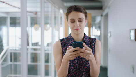 beautiful-business-woman-using-smartphone-walking-through-office-texting-sending-emails-successful-female-executive-checking-messages-on-mobile-phone-arriving-at-workplace-4k